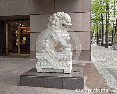 White marble male guardian lion at entrance to the Crow Museum of Asian Art in downtown Dallas, Texas Editorial Stock Photo