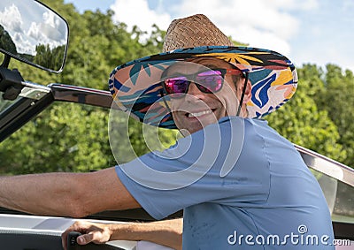 Closeup front view of a forty-four year-old Caucasian man driving a ski boat on Grand Lake in Oklahoma. Stock Photo
