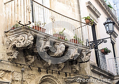 Old crumbling baroque balcony with planters, Lecce Italy Stock Photo