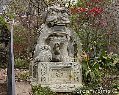 Male Chinese guardian Lion at the entrance to Dragon Park in the Oak Lawn neighborhood in Dallas, Texas. Stock Photo