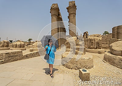 Female Korean tourist before the Colonnade Hall of Amenhotep III and Tutankhamun from the Amenhotep III Court of the Luxor Temple. Stock Photo