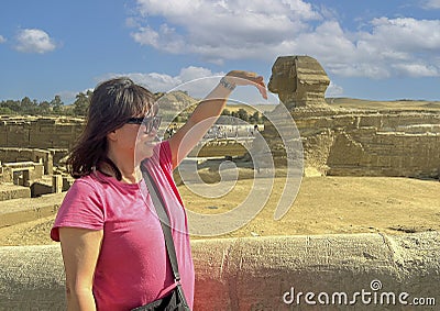 Female Korean tourist and The Great Sphinx of Giza, on the Giza Plateau in Giza, Egypt. Stock Photo