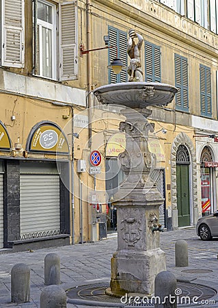 Fountain with child drinking from a shell in Genoa, northern Italy Editorial Stock Photo