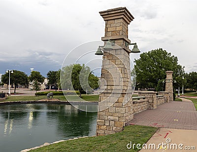 Gaylord Bridge and one of many bronze steers, part of the longest bronze sculpture collection in the United States Stock Photo