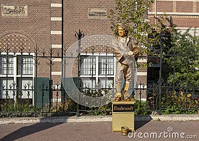 Golden living statue of Rembrandt, outside the Rijksmuseum, Amsterdam, Netherlands Editorial Stock Photo