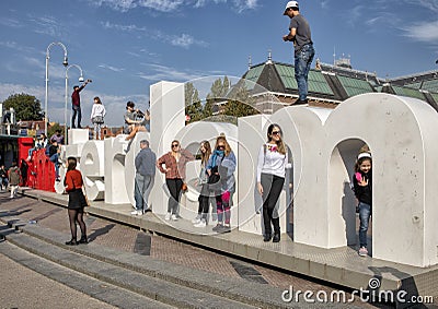 Tourists and the `I amsterdam` sculpture in front of The Rijksmuseum from the Museumplein, Amsterdam, Netherlands Editorial Stock Photo