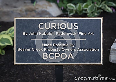 Information plaque for a bronze sculptures of a mother black bear and her cubs in Beaver Creek, Colorado. Editorial Stock Photo