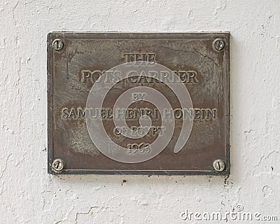 Information plaque for `The Pots Carrier`, a bronze sculpture by Samuel Henri Honein outside the World Trade Center in Dallas Editorial Stock Photo