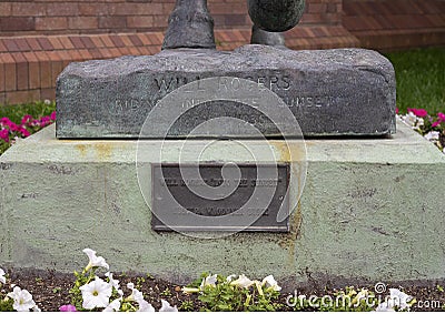 Information stone and plaque, Bronze sculpture Will Rogers on his horse Soapsuds in front of the Hotel Anatole in Dallas, Texas. Editorial Stock Photo