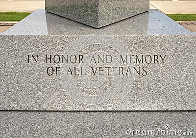 Inscription base of granite obelisk memorial honoring all Veterans in Vandergriff Park in the City of Arlington, Texas. Stock Photo