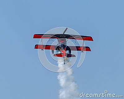 Jeremy Holt piloting his Pegasus Pitts Model 12 acrobatic biplane in the airshow July 4th at Grand Lake, Oklahoma. Editorial Stock Photo