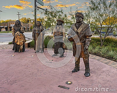 Life-size bronze sculpture of four chiefs by Linda Lewis, part of an art piece titled `The Peace Circle` in historic Grapevine. Editorial Stock Photo