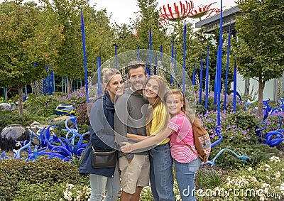 Family posing before outdoor exhibit in the garden, Chihuly Garden and Glass in the Seattle Center Editorial Stock Photo