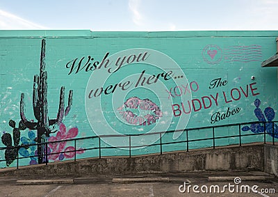 Mural on the side of a business in the Design District in Dallas, Texas featuring the BuddyLove brand. Editorial Stock Photo