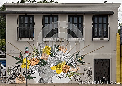 Mural titled Dea painted by artist Alli Koch on the side of the Dea Restaurant in Dallas, Texas. Editorial Stock Photo