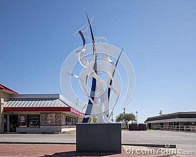 Figurative steel sculpture by Joshua Weiner on 15th Street in Plano, Texas. Editorial Stock Photo