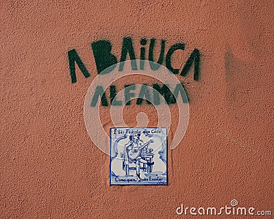 Painted tile representing Fado on an outside wall of the small fado restaurant Baiuca in Alfama. Editorial Stock Photo