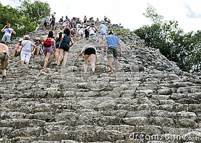 People climbing up an down the Nohoch Mul Pyramid in the Coba ruins Editorial Stock Photo