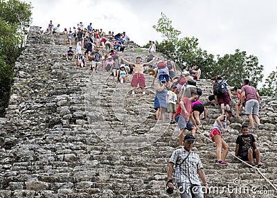 People climbing up an down the Nohoch Mul Pyramid in the Coba ruins Editorial Stock Photo