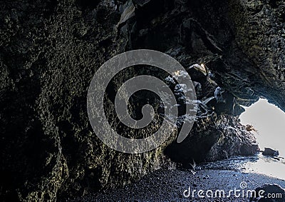 Rugged lava tunnel next to the Black sand beach on the Island of Maui in the State of Hawaii. Stock Photo