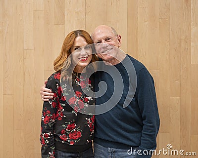 Seventy-three year-old father in an affectionate pose with his forty-eight year-old daughter after a dance performance. Stock Photo