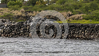 Small portion of the Kaloko Fishpond kuapa or seawall made of interlocking lava rocks on the Big Island, Hawaii. Stock Photo