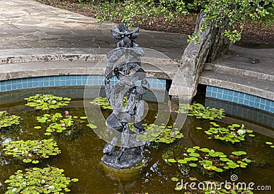 Springstone sculpture titled Fish Shoal by Shepherd Deve in the Fort Worth Botanic Garden. Editorial Stock Photo