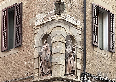 Statue of Saint Anthony of Padua and another Franciscan Friar in abutting niches in Bologna, Italy. Stock Photo