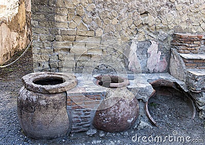 Street food bar with pots to keep food hot in the remains of Herculaneum Parco Archeologico di Ercolano Editorial Stock Photo