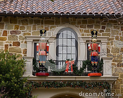 Two Nutcrackers guarding the door of a balcony on the second floor of a mansion in Highland Park at Christmas, Texas Stock Photo
