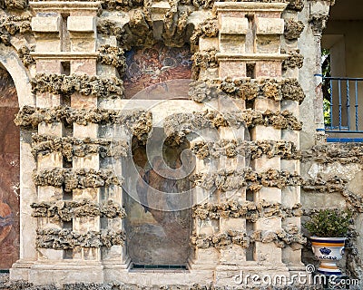 Two of several frescoes by Diego Esquivel in the textured wall behind the Mercury pond in the gardens of Real Alcazar in Seville. Stock Photo