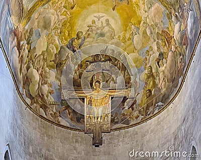 Unique painted wooden cross suspended above the main altar in the Cathedral of Saint martin in Lucca, Italy. Editorial Stock Photo