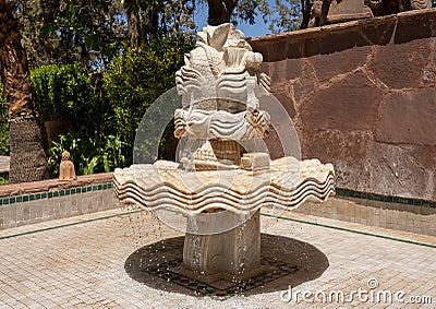 White marble centerpiece of a fountain in an outside courtyard of the Kasbah Tamadot, Sir Richard Branson`s Moroccan Retreat. Editorial Stock Photo