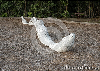 Stone rattlesnake sculpture at the north end of the Galatyn Naure Trail in Richardson, Texas. Editorial Stock Photo