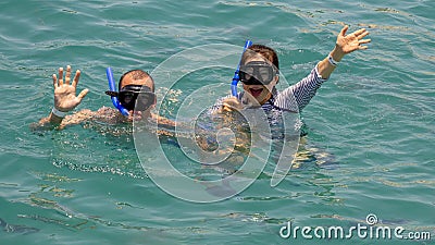 47 year-old Caucasian husband and his 57 year-old Korean wife enjoying snorkeling in Santa Maria Bay near San Cabo Lucas Stock Photo