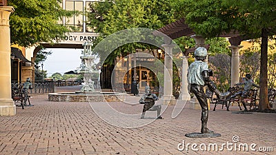 Young athletes and bronze, ornate fountain sculpture at The Village at Sports Center in Arlington, Texas. Editorial Stock Photo