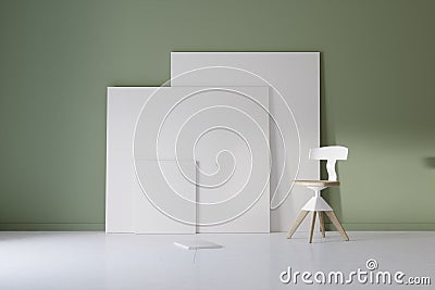 Pictures and chair in green studio with atmospheric lighting Stock Photo