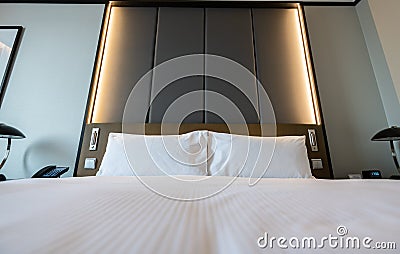 Pictures of a generic hotel room - Bed, window, table, lamps all in shot. Stock Photo