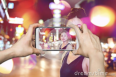 Pictures on mobile smart phone Girl walking on the night city street with broken effect Stock Photo