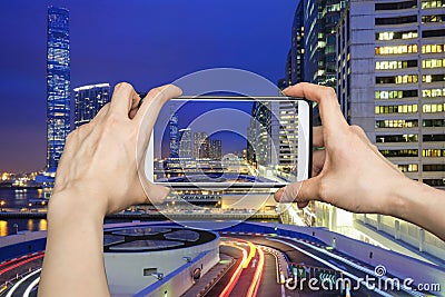 Pictures on mobile smart phone in Night view traffic in Hong Kong at sunset time Stock Photo