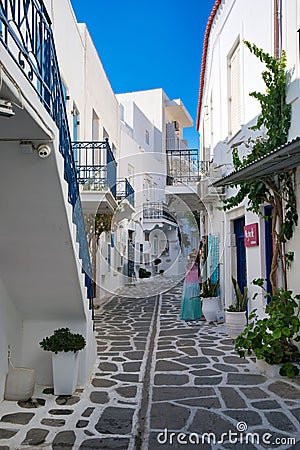 Picturesque alleyway featuring blue balconies of white buildings. Parikia, Paros, Greece. Editorial Stock Photo