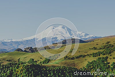 Picturesque beautiful view of Elbrus, green fields and beautiful natural nature of the Caucasian mountains, the concept of travel Stock Photo
