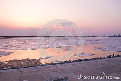 Picturesque colorful ice drift on a calm wide river during the pink sunset Stock Photo