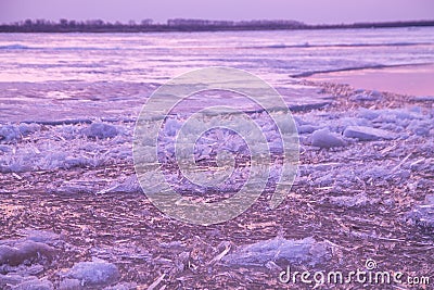 Picturesque colorful ice drift on a calm wide river during the pink sunset Stock Photo