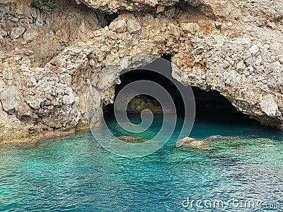 Picturesque entrance to the cave. Grotto Stock Photo