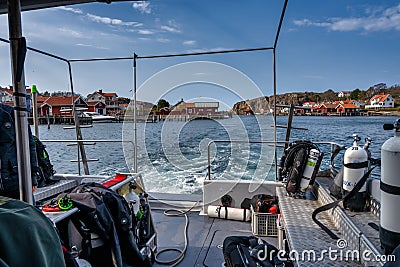 A picturesque fishing village on the Swedish West coast seen from the deck of a dive boat. Traditional red sea huts and Editorial Stock Photo