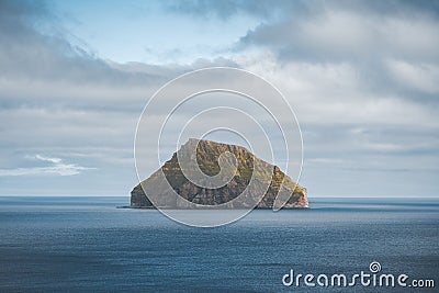 Picturesque green cliffs on Litla Dimun island and atlantic ocean in Faroe islands. Stock Photo