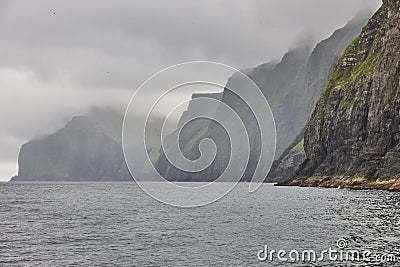 Picturesque green cliffs shoreline and atlantic ocean. Faroe islands Stock Photo