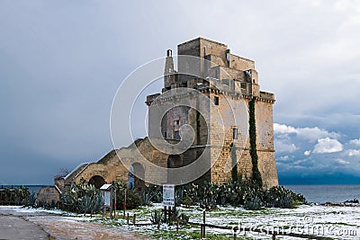 Picturesque historical fortification tower Torre Colimena in the snow Editorial Stock Photo