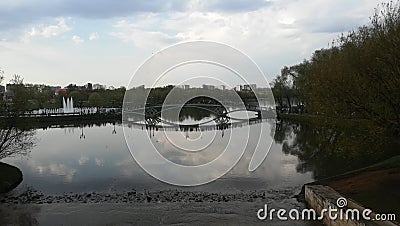 a picturesque lake a beautifully shaped bridge and a fountain in a Moscow park Stock Photo